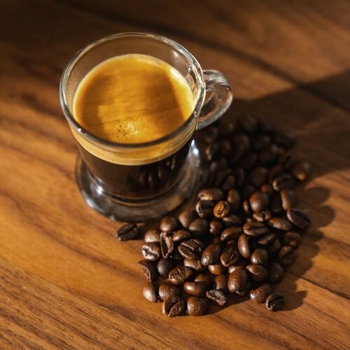 Taza de espresso con granos de café en una mesa de madera.